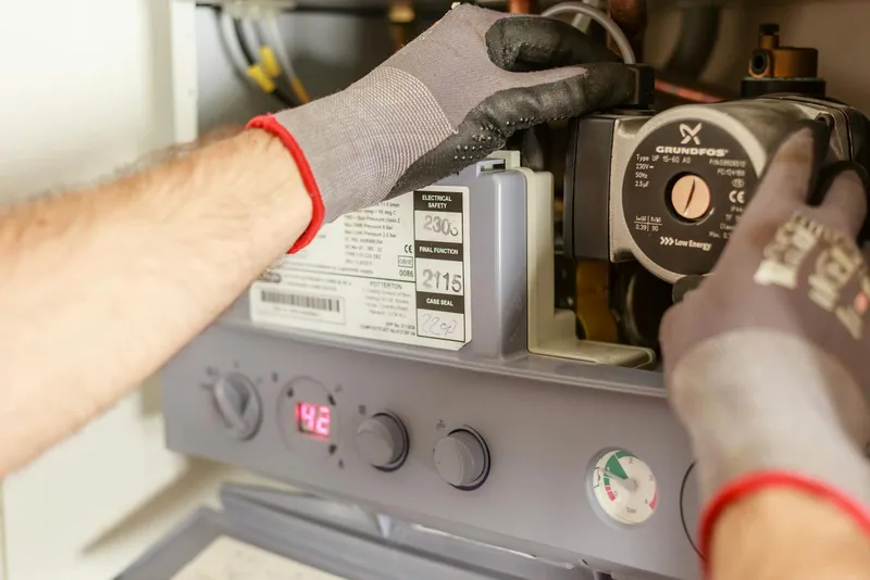 Technician performing gas fireplace safety inspection in Bellevue WA