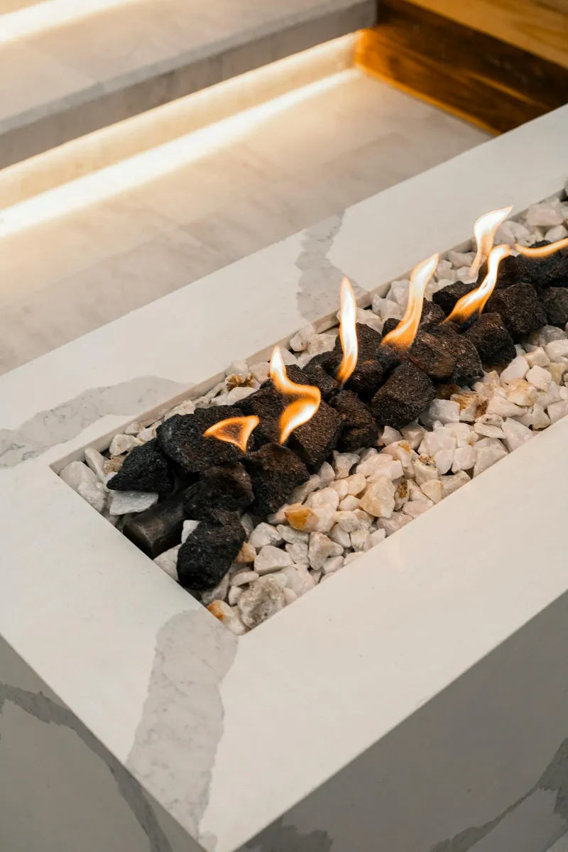 Modern gas fireplace with decorative stones and flames