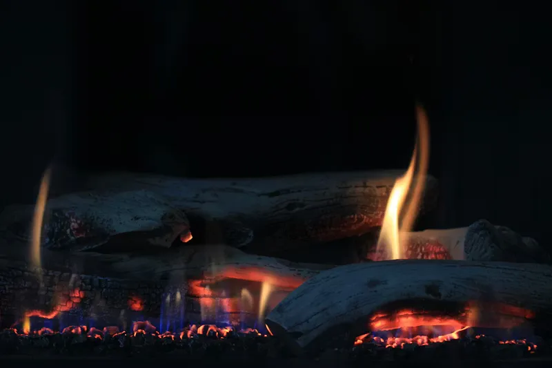 Gas logs burning with realistic flame in a fireplace