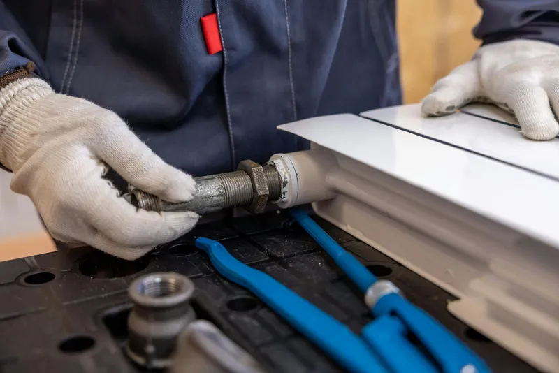 Technician servicing a gas heating system