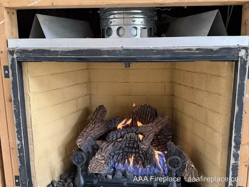 Vented gas log set installed and burning in a customer's fireplace